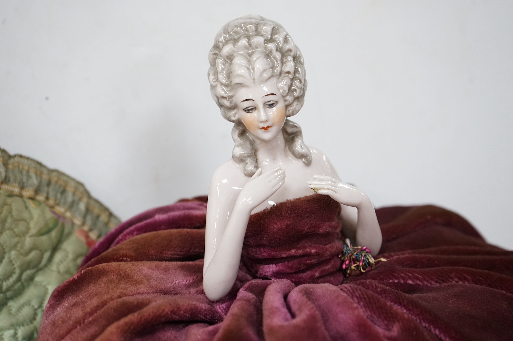 A pin doll, a fabric tea cosy and various hair ornaments, cosy 30cm high. Condition - variable